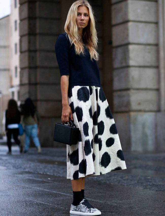 Rien de tel qu'une paire de baskets et un fin sweat pour twister une jupe midi sophistiqu�e