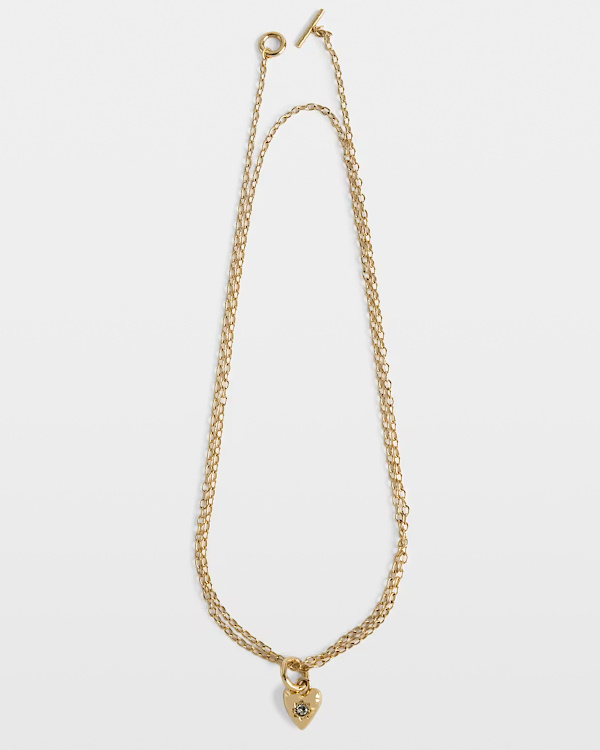 Sautoir en laiton doré à pendentif coeur.